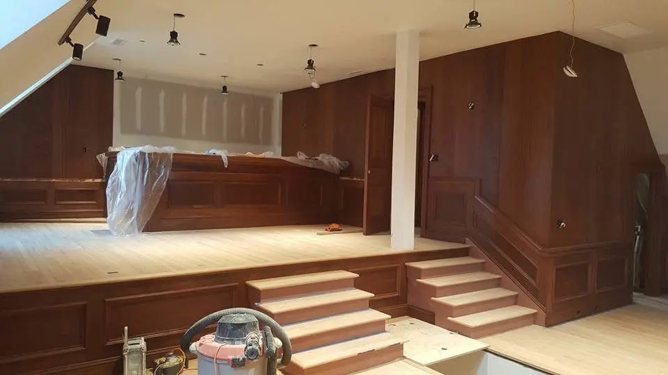 Basement renovation with wood paneling, built-in cabinetry and new steps in progress - Greater Homes Solutions LLC